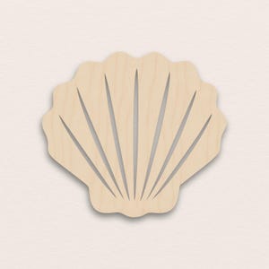 May include: A light-coloured wooden seashell cutout with a scalloped edge and radiating lines. The design is simple and natural, ideal for coastal decor or craft projects. The wood grain is visible.