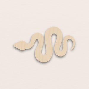 May include: A light beige wooden snake cutout. The snake is depicted in a winding, curved posture, with a triangular head and a rounded tail. The cutout has a smooth finish and displays the natural grain of the wood.