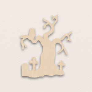 May include: A wooden cutout of a spooky tree with a perched owl, two tombstones, and a gnarled trunk and branches. The cutout is made of light-colored wood and is suitable for Halloween or fall-themed crafts.