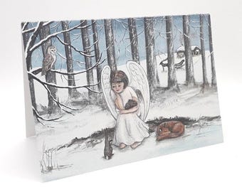 May include: A watercolor painting of an angel with wings, wearing a white dress and holding a small animal. The angel is standing in a snowy forest with trees and a small house in the background.