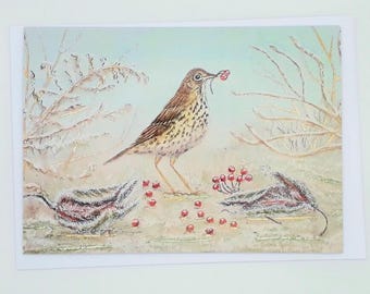 May include: A watercolor painting of a bird with brown and white speckled feathers, holding red berries in its beak. The bird stands among fallen leaves and more red berries. The background features frosted branches and a pale blue sky.