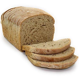 May include: A loaf of sliced rye bread with a few slices removed. The bread is a light brown color and has a slightly rough texture.