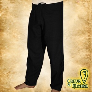 May include: Black linen pants with a drawstring waist. The pants are loose fitting and have a simple design.