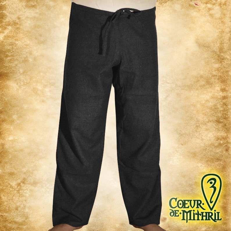 May include: Black drawstring pants made of a soft, woven fabric. The pants have a relaxed fit and a simple design.