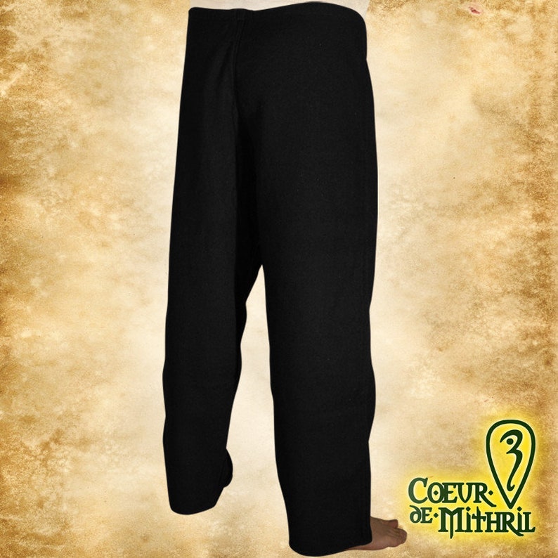 May include: Black pants with a straight leg and a wide waistband. The pants are made of a thick, woven fabric.