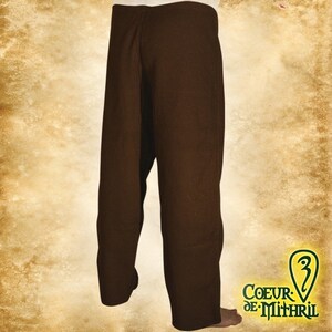 May include: Brown linen pants with a straight leg and a simple design. The pants are made of a soft, comfortable fabric and have a relaxed fit.
