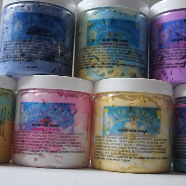 May include: Six jars of whipped soap with colorful swirls and glitter. The jars are labeled with the names of the scents: "Yummy Gummy", "Candy Crush", "Watermelon", "Birthday Cake", and two others that are not visible in the image.