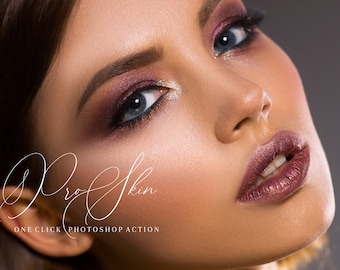 May include: Close-up of a woman's face with dramatic eye makeup featuring shimmery pink and brown eyeshadow, black eyeliner, and long lashes. Her lips are a deep, rich burgundy colour. The text "Pro Skin One Click Photoshop Action" is visible at the bottom of the image.