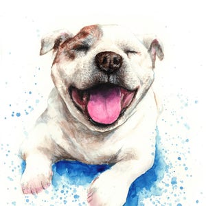 May include: Watercolor painting of a white dog with brown markings, smiling with its tongue out. The dog is lying down on a blue background with white splatter paint. The dog's name, "Ronnie", is written in cursive at the bottom of the painting.