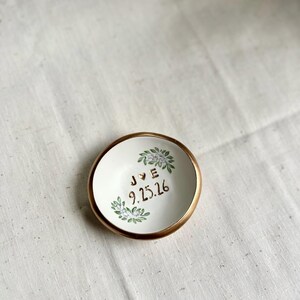 May include: A trio of ceramic mugs with a speckled, matte finish in cream, light grey, and dark grey. Each mug features a simple, minimalist design, ideal for tea or coffee.