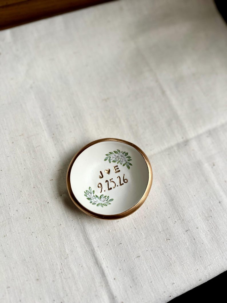 May include: A trio of ceramic mugs with a speckled, matte finish in cream, light grey, and dark grey. Each mug features a simple, minimalist design, ideal for tea or coffee.