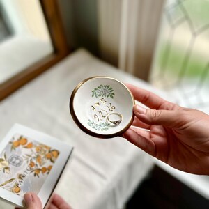 May include: A trio of ceramic mugs with a speckled, matte finish in cream, light grey, and dark grey. Each mug features a simple, minimalist design, ideal for tea or coffee.