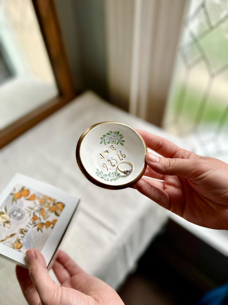 May include: A trio of ceramic mugs with a speckled, matte finish in cream, light grey, and dark grey. Each mug features a simple, minimalist design, ideal for tea or coffee.