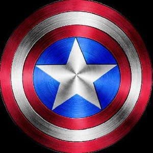 May include: A red, white, and blue circular shield with a white five-pointed star in the center. The shield has a metallic finish.