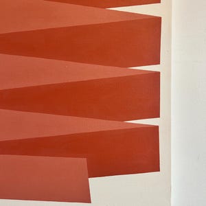 May include: Abstract painting with a geometric design of overlapping red and orange stripes. The stripes are arranged in a diagonal pattern, creating a sense of movement and depth.