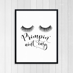 May include: Black and white printable wall art with a pair of eyelashes and the text "Primpin' ain't easy".