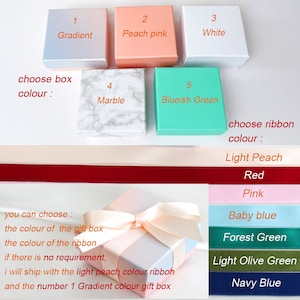 May include: Five square gift boxes in gradient, peach pink, white, marble, and blueish green colors. Below are ribbons in light peach, red, pink, baby blue, forest green, light olive green, and navy blue. A gradient box with a light peach ribbon.