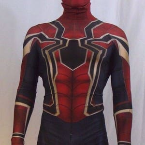 May include: A red and black spandex costume with a spider design. The costume has a red mask with a white spider design. The costume is a full-body suit with long sleeves and trousers.