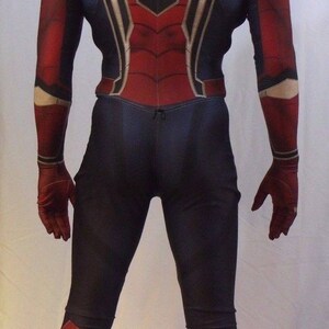May include: A red and blue spandex costume with a spider design on the back. The costume has a hood and gloves.