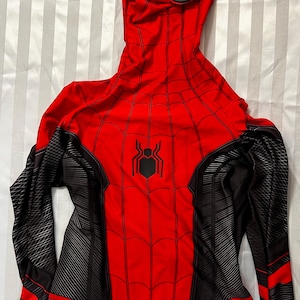 May include: Red and black Spider-Man costume with a black spider logo on the chest. The costume has a hood with a white eye mask.