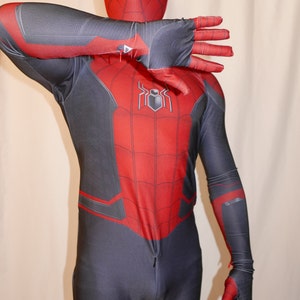 May include: A red and black spandex costume with a spider logo on the chest. The costume has a zip in the front and a mask with a spider design.
