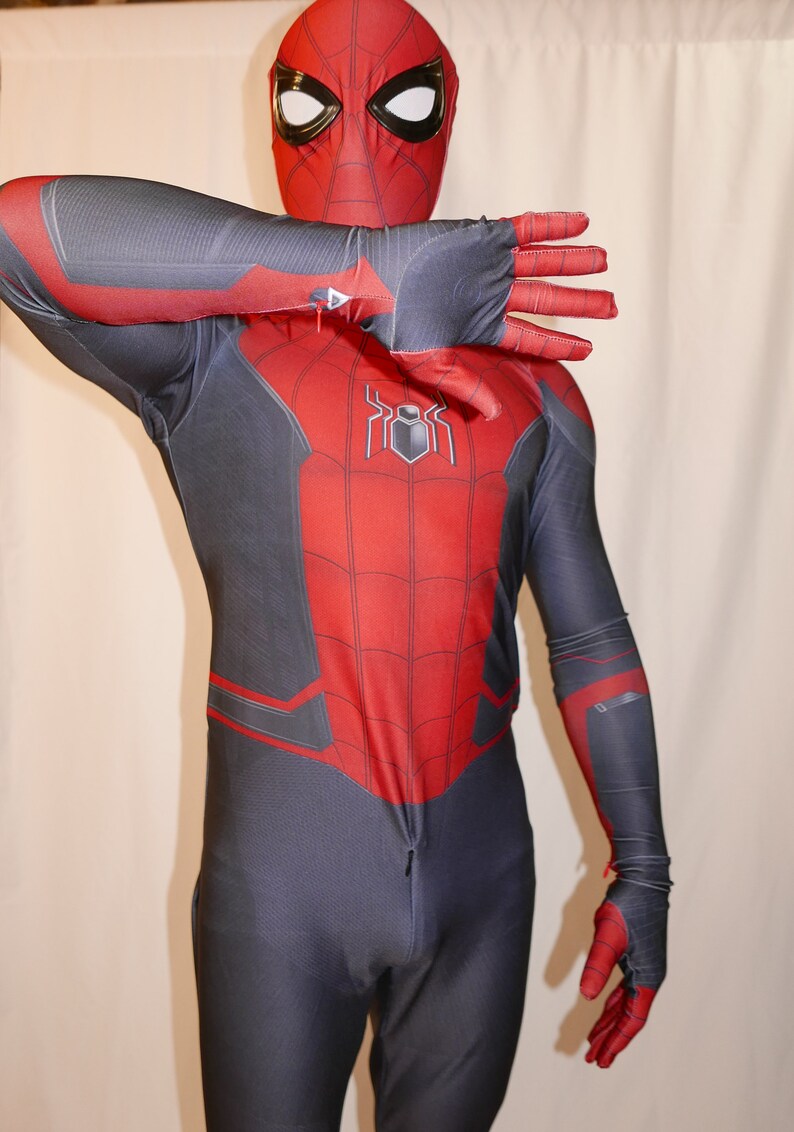 May include: A red and black spandex costume with a spider logo on the chest. The costume has a zip in the front and a mask with a spider design.
