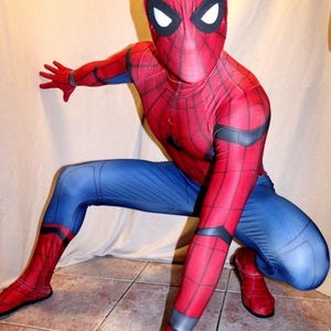 May include: A red and blue Spiderman costume with a black spider web design. The costume has a mask with white eyes.