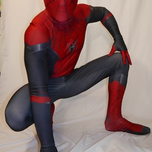 May include: A red and black Spiderman costume with a black mask and a spider logo on the chest. The costume is made of a stretchy material and has a sleek design.
