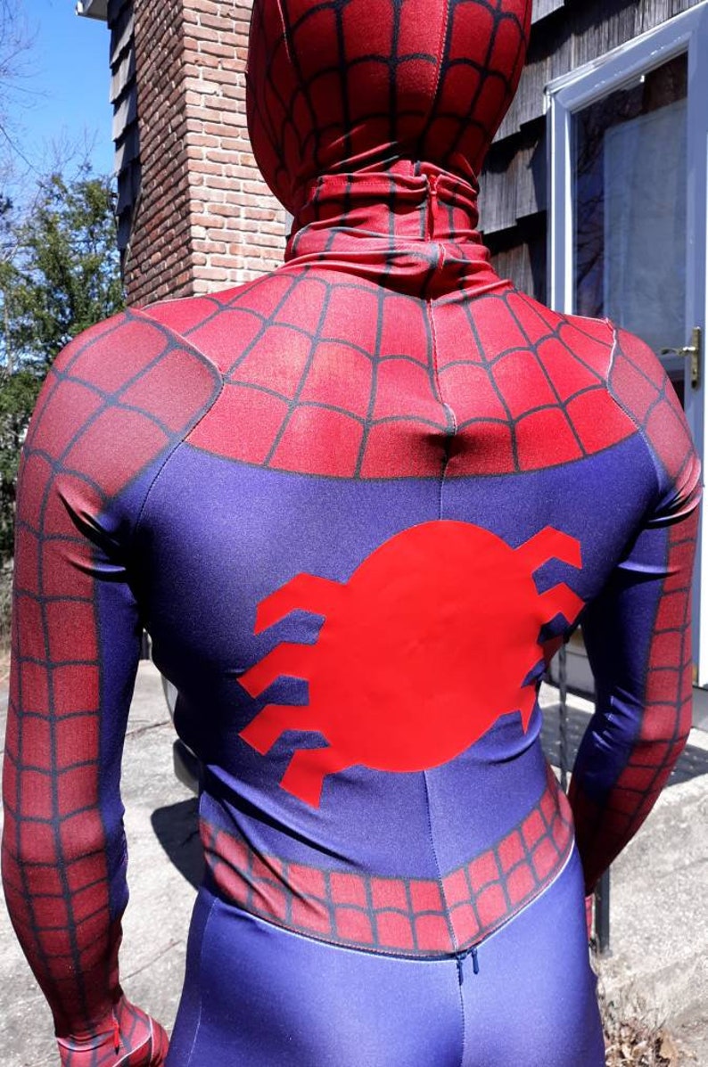 May include: A red and blue spandex costume with a spider logo on the back. The costume has a zipper in the back and a web pattern on the front and back.
