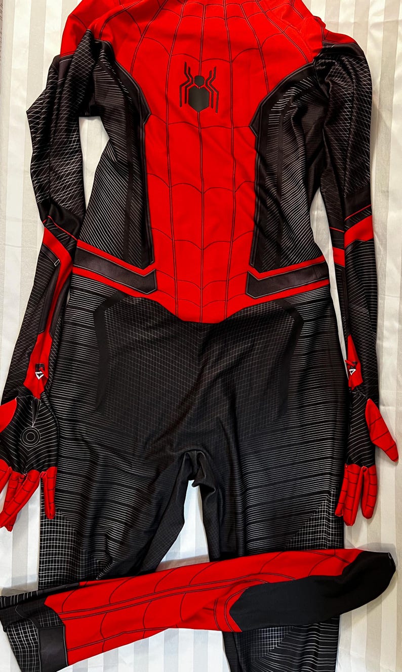 May include: Red and black spandex costume with a spider logo on the chest. The costume has a web pattern and black accents.
