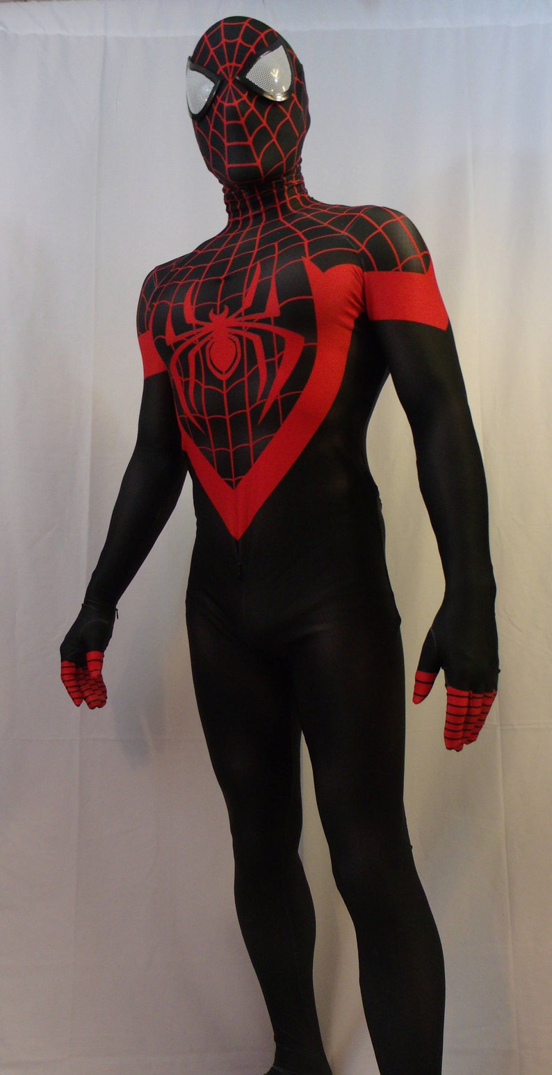May include: A black and red spandex costume with a spider symbol on the chest. The costume has a black mask with a spider web design and white eyes.