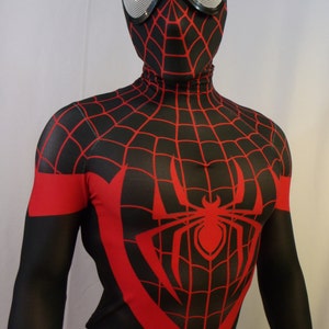 May include: A black and red spandex costume with a spider web design. The costume has a red spider symbol on the chest and a black mask with a red spider web design.