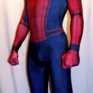 May include: A red and blue spandex costume of Spider-Man with a black spider logo on the chest. The costume has a red mask with black eyes and a black web design.
