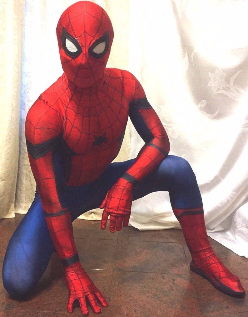 May include: A red and blue spandex superhero costume with a spider web design. The costume includes a mask with white eyes and a black spider logo on the chest.