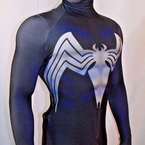 May include: Black and blue spandex costume with a white Venom symbol on the chest. The costume has a black mask with white mesh eye coverings.
