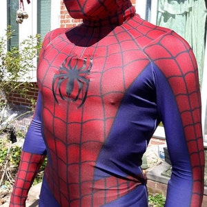 May include: A red and blue spandex costume with a spider logo on the chest. The costume has a mask with a white eye design.