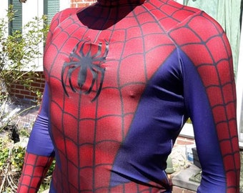May include: A red and blue spandex costume with a spider logo on the chest. The costume has a mask with a white eye design.