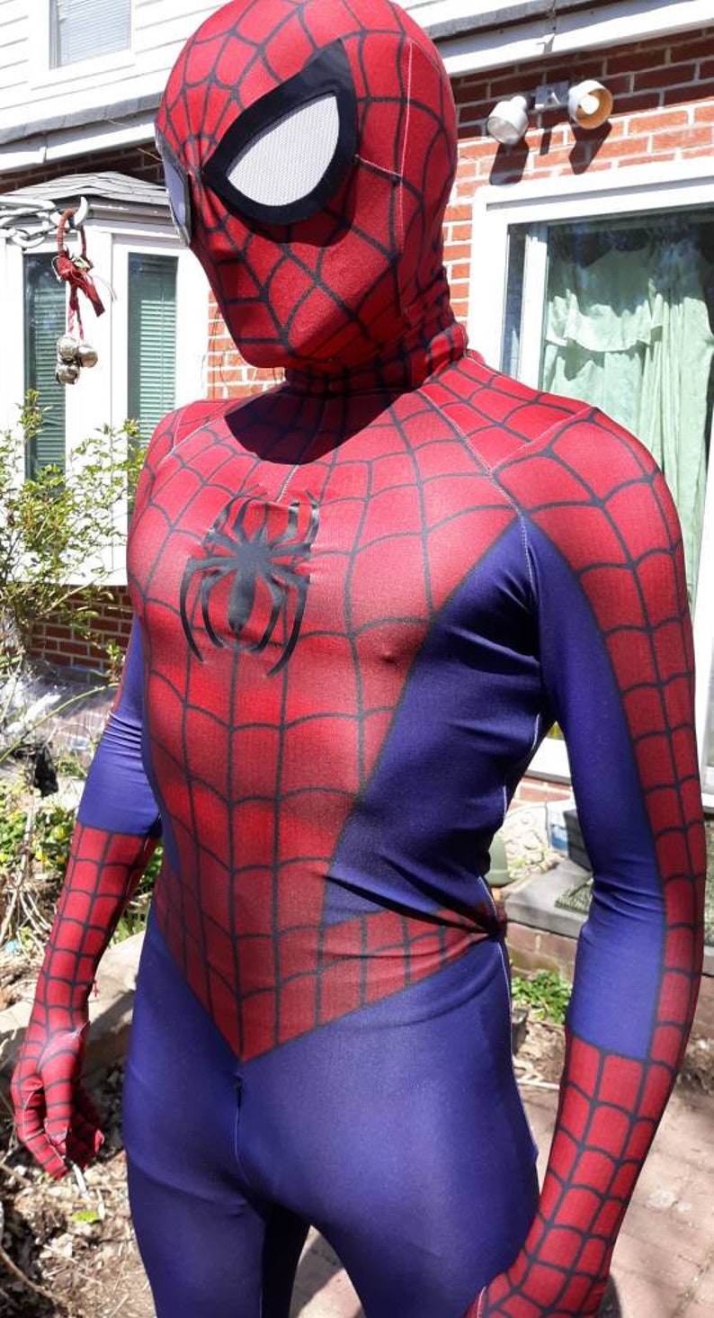 May include: A red and blue spandex costume with a spider logo on the chest. The costume has a mask with a white eye design.