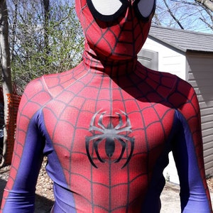 May include: A red and blue spandex costume with a black spider logo on the chest. The costume has a red mask with white eyes.
