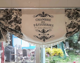May include: A white valance with black and white toile fabric on the sides and a black and white sign in the centre that reads "Chambre des Pâtisseries No. 52 Rue Gâteau Sucré Paris".