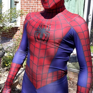 May include: A red and blue spandex costume with a spider logo on the chest. The costume has a mask with a white spider design.
