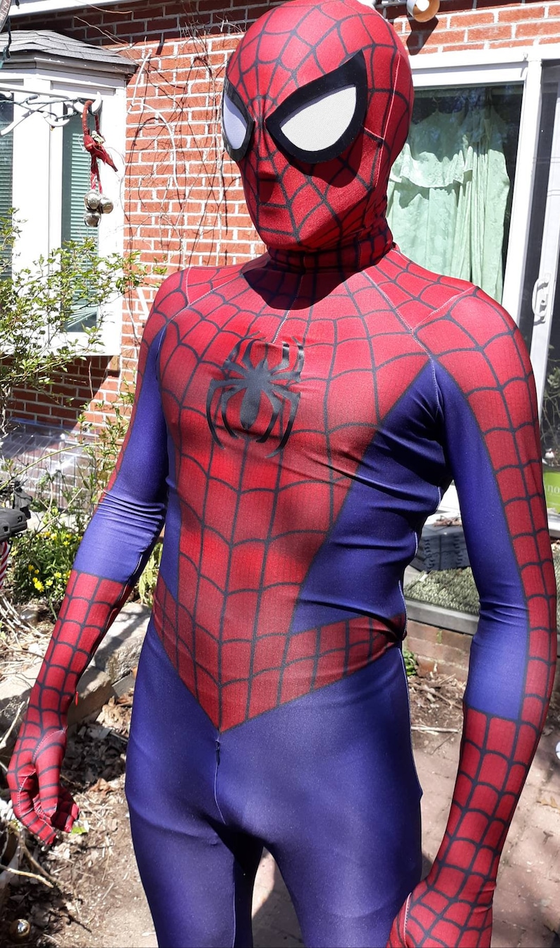 May include: A red and blue spandex costume with a spider logo on the chest. The costume has a mask with a white spider design.