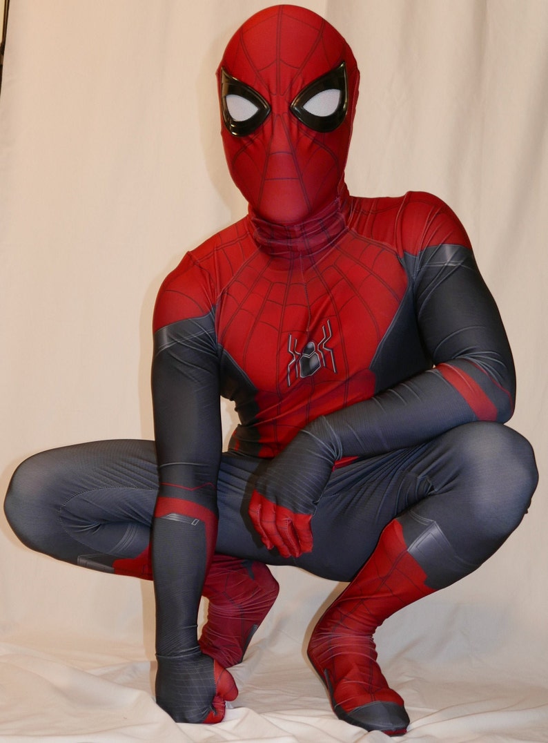 May include: A red and black spandex superhero costume with a spider logo on the chest. The costume has a mask with a red and black design and white eyes.
