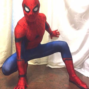 May include: A red and blue Spiderman costume with a mask. The costume has a spider web design on the chest and legs.