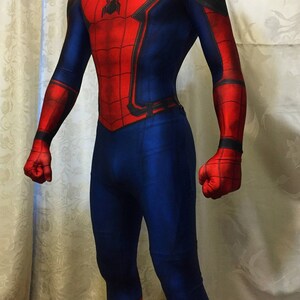 May include: A red and blue spandex costume of Spider-Man with a black spider logo on the chest. The costume has a red mask with black eyes.