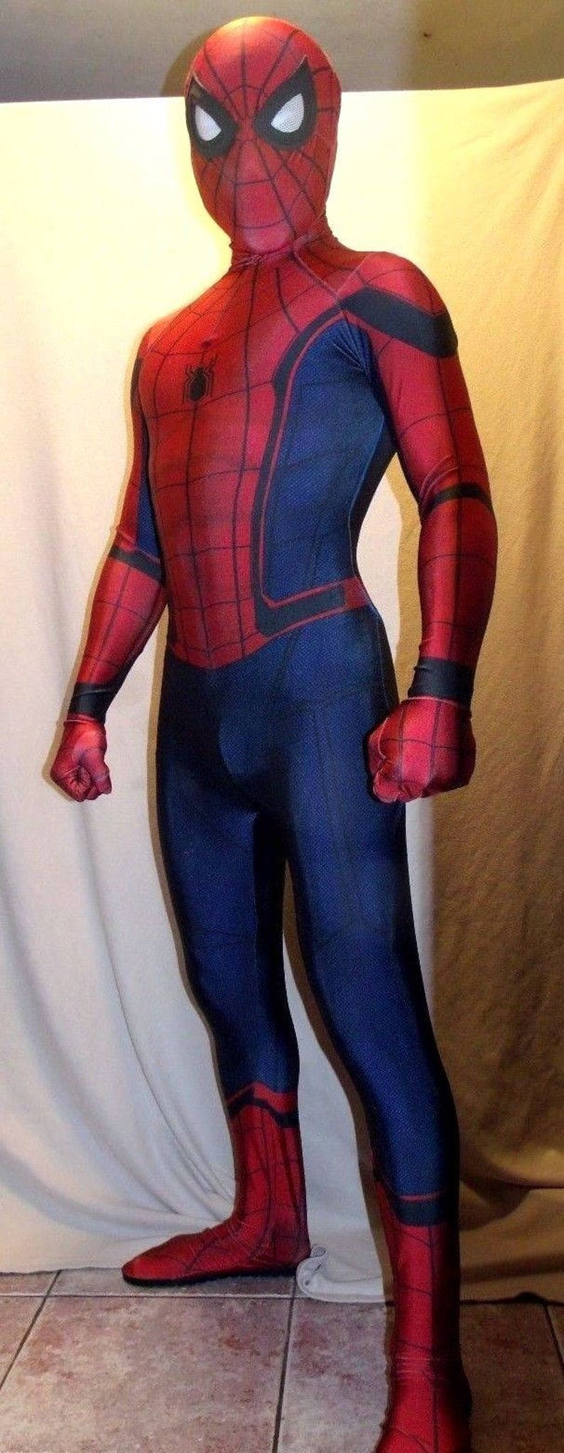 May include: A red and blue Spiderman costume with a black spider logo on the chest. The costume has a red mask with black eyes and a web pattern.
