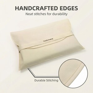 May include: A cream-colored rectangular pillowcase with a flap closure and a strap. The text "HANDCRAFTED EDGES" and "Neat stitches for durability" are at the top. The text "Durable Stitching" is at the bottom. The brand name "TreePackaging" is printed on the strap.