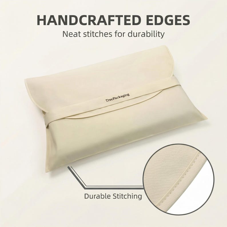 May include: A cream-colored rectangular pillowcase with a flap closure and a strap. The text "HANDCRAFTED EDGES" and "Neat stitches for durability" are at the top. The text "Durable Stitching" is at the bottom. The brand name "TreePackaging" is printed on the strap.