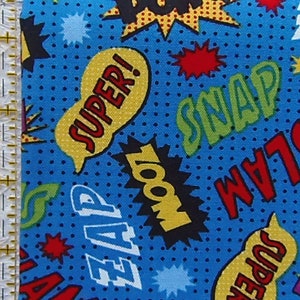 May include: Blue fabric with a repeating pattern of colorful comic book sound effects like "Super!" "Snap!" "Zap!" and "Slam!" The background is a blue dotted pattern.