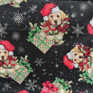 May include: A repeating pattern on a black background features festive elements. Golden retriever puppies wearing Santa hats and surrounded by gifts and holly are interspersed with snowflakes. The gifts are wrapped in red and green plaid.